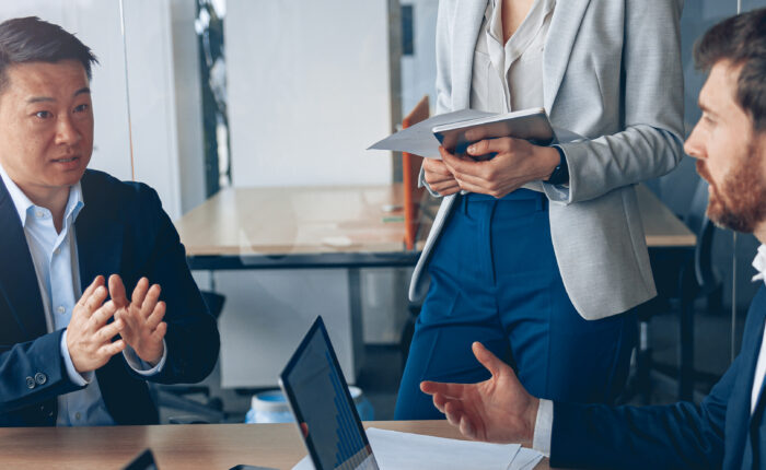 Business professionals discussing technology needs in a meeting