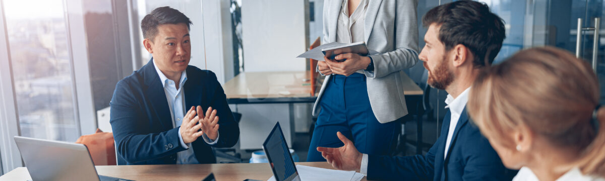 Business professionals discussing technology needs in a meeting